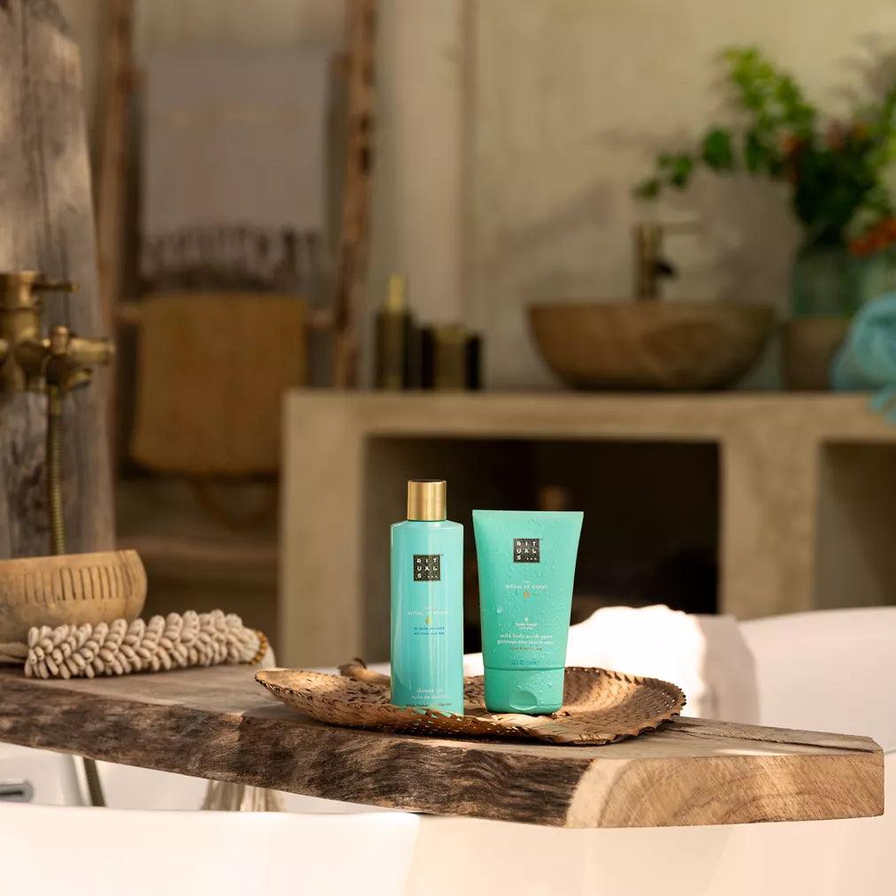 RITUALS shower oil and body cream on a wooden tray, set in a serene bathroom environment.