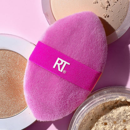 Pink makeup sponge with 'RT' logo on a pink background