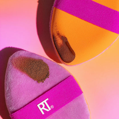 Makeup sponge with brown powder and 'RT' logo on a colorful background