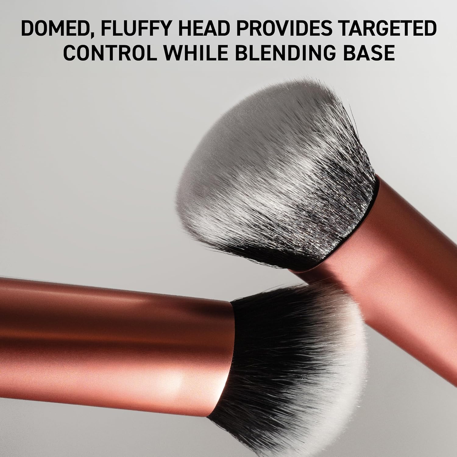 Makeup brush with a domed, fluffy head on a gray background