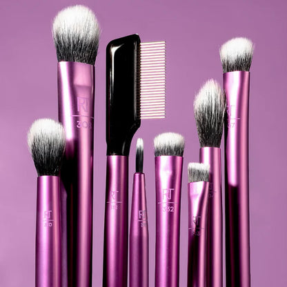 Set of pink makeup brushes with visible brand logo on a purple background