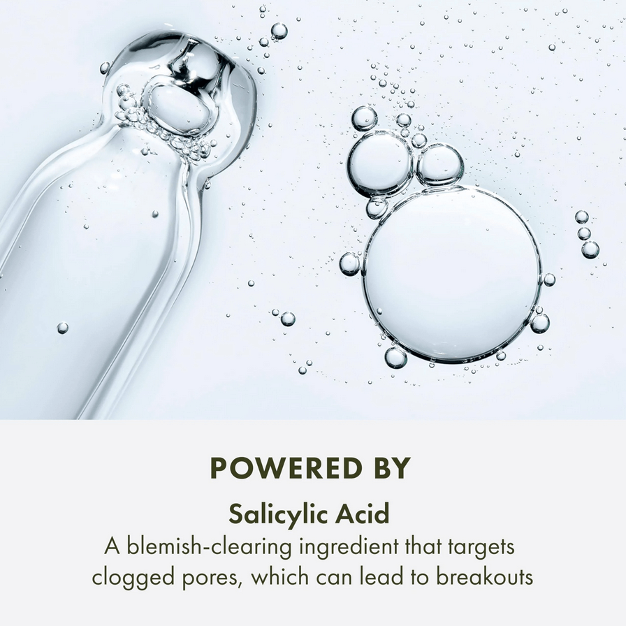 Bottle of Origins  skincare product with bubbles and text about salicylic acid on a light background