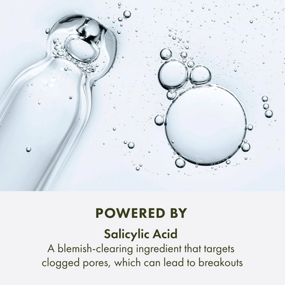 Bottle of Origins  skincare product with bubbles and text about salicylic acid on a light background