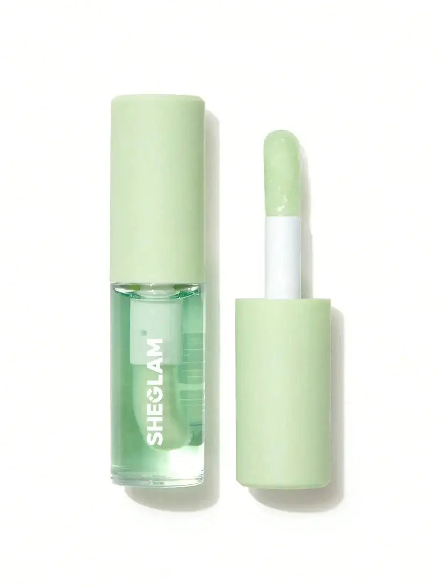 SHEGLAM Jelly Wow Hydrating Lip Oil in green packaging with applicator, infused with blueberry extract and hyaluronic acid.