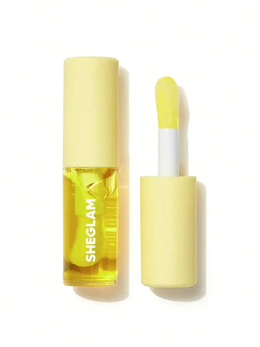 SHEGLAM Jelly Wow hydrating lip oil in a yellow tube with applicator, delivering moisturizing shine with blueberry extract.