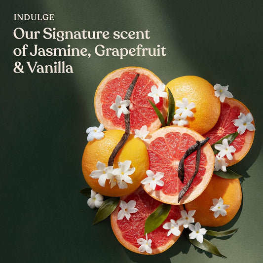 Sanctuary Spa Fruit arrangement with flowers and text on a dark background