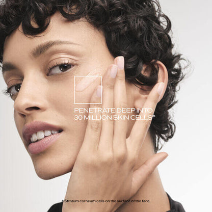 Model applying Shiseido skincare product to her face, highlighting deep penetration into skin cells.