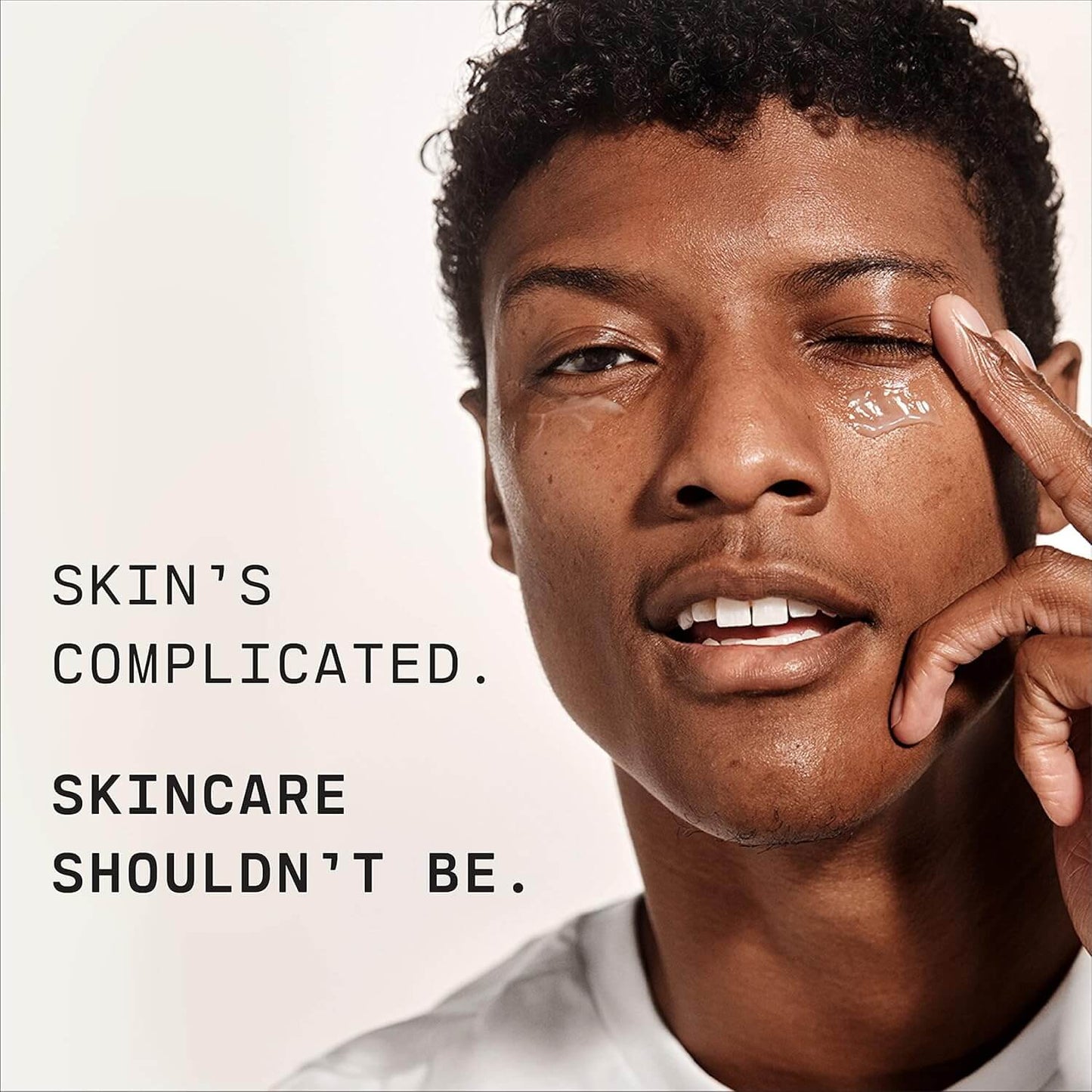 A man with clear skin promoting simple skincare, emphasizing that while skin is complicated, caring for it doesn’t have to be.