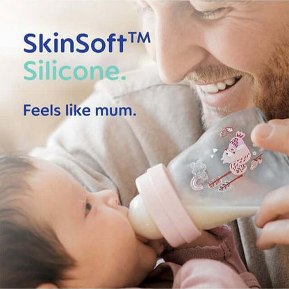 Father feeding baby with MAM SkinSoft silicone bottle, promoting natural feel and comfort for infants.