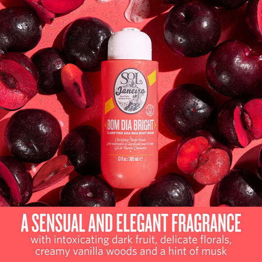 Sol de Janeiro Bom Dia Bright Clarifying AHA BHA Body Wash surrounded by dark fruit and floral elements.