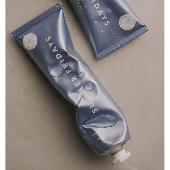 Blue tube of Summer Fridays product on a beige background