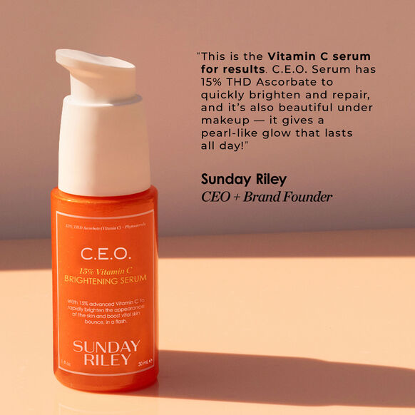 Orange serum bottle with white pump on a beige background, featuring Sunday Riley branding.