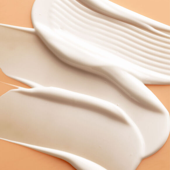 Close-up of beige Sunday Riley gel pads on a peach background