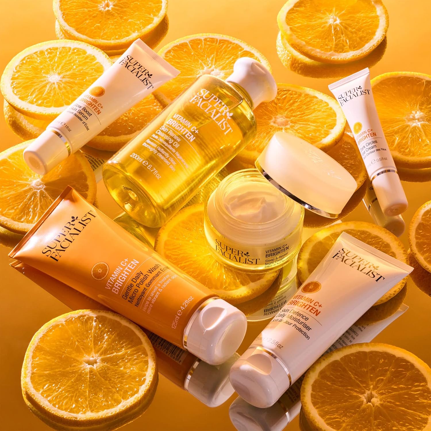 Superfacialist  skincare products with sliced oranges on a yellow background