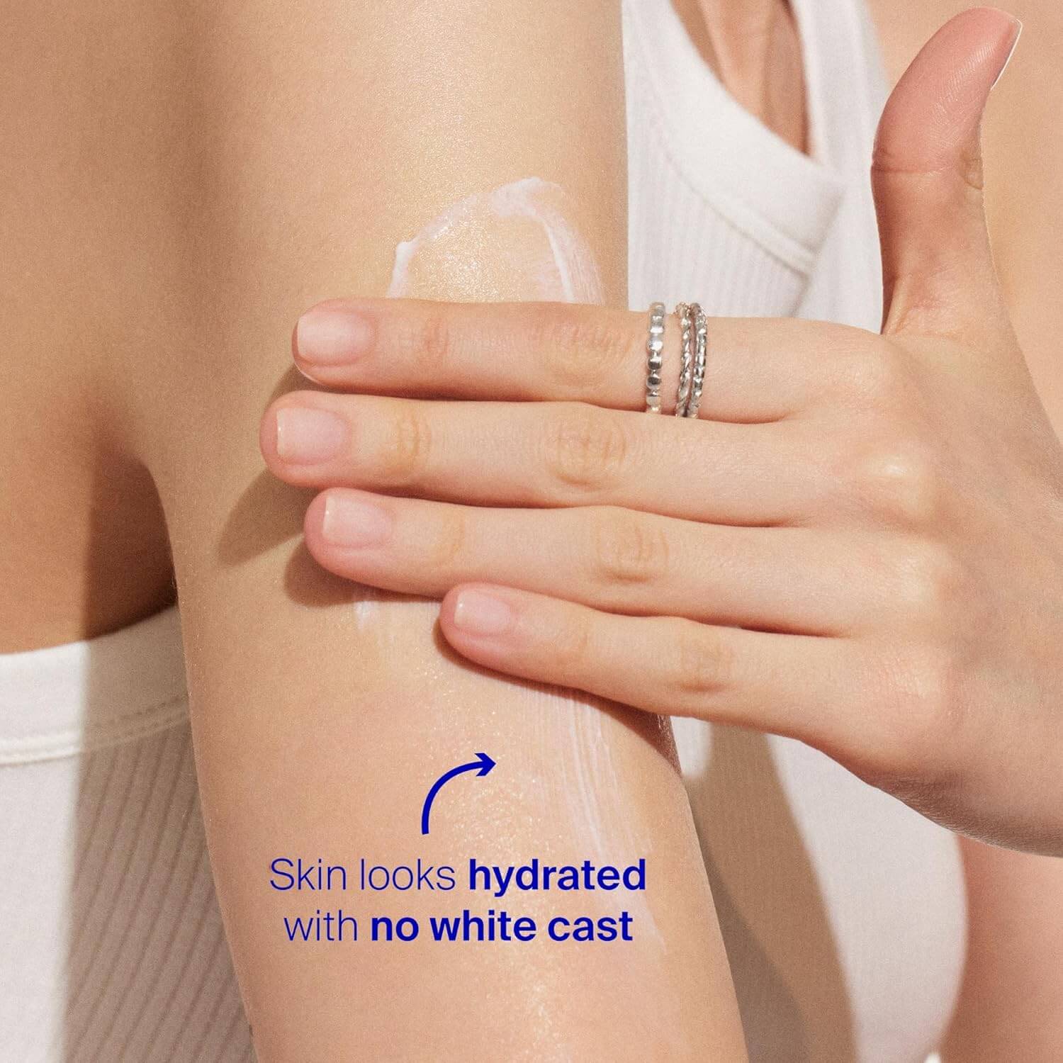 Person applying a Supergoop product to their arm with text indicating skin hydration.