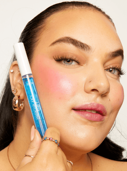 Model showcasing Tarte Maracuja Juicy Lip & Cheek Shift in Blueberry, highlighting natural glow and personalized color on cheeks.