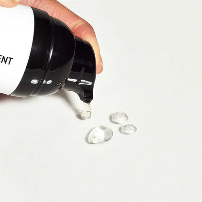 The Inkey List C-50 Blemish Night Treatment being dispensed with gel droplets on a surface.