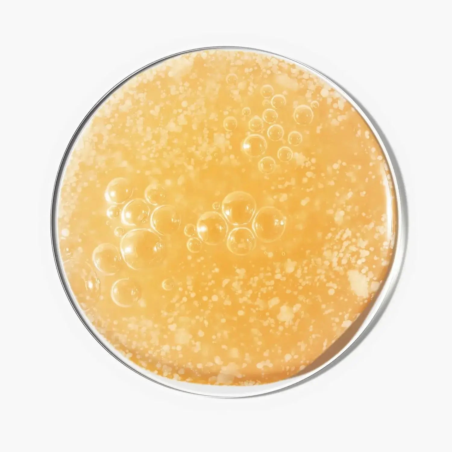 Close-up of The INKEY List Glycolic Acid Exfoliating Scalp Scrub showing bubbly exfoliating texture.