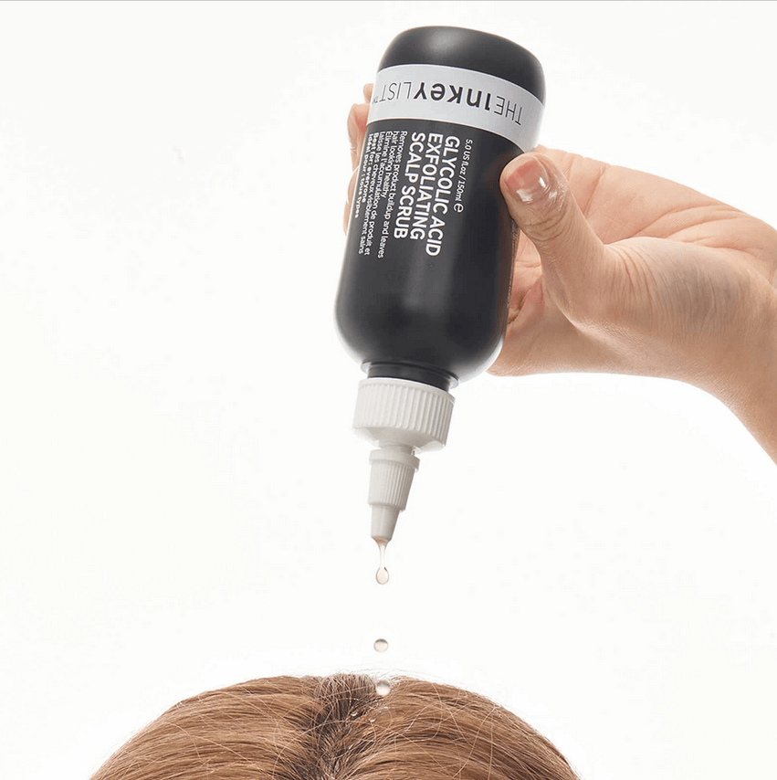 The INKEY List Glycolic Acid Exfoliating Scalp Scrub being applied to a person's scalp for revitalizing hair care.