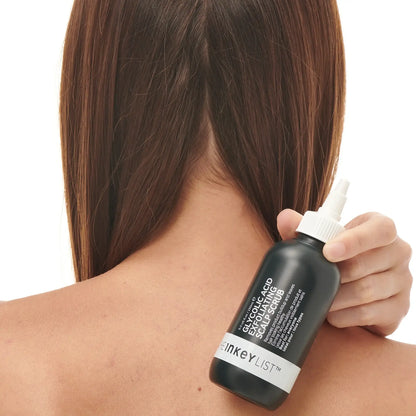 Glycolic Acid Exfoliating Scalp Scrub 150ml being applied to a woman's scalp for revitalization.