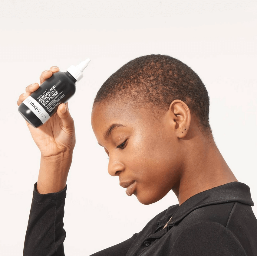 Model using The INKEY List Glycolic Acid Exfoliating Scalp Scrub for a refreshed scalp and vibrant hair.