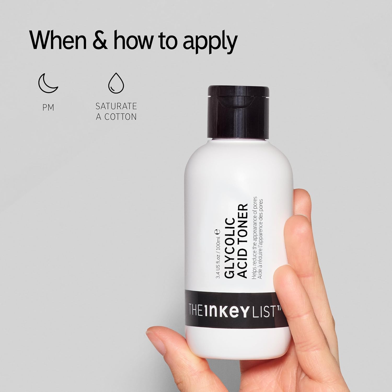 Hand holding a bottle of The Inkey List Glycolic Acid Toner with application instructions on a gray background.