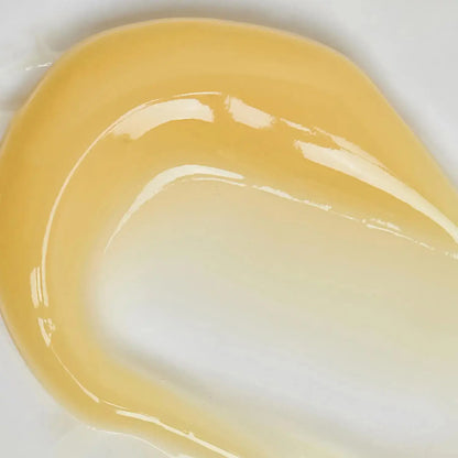 Close-up of The INKEY List Retinol Serum texture showing a smooth, golden gel consistency on white background.