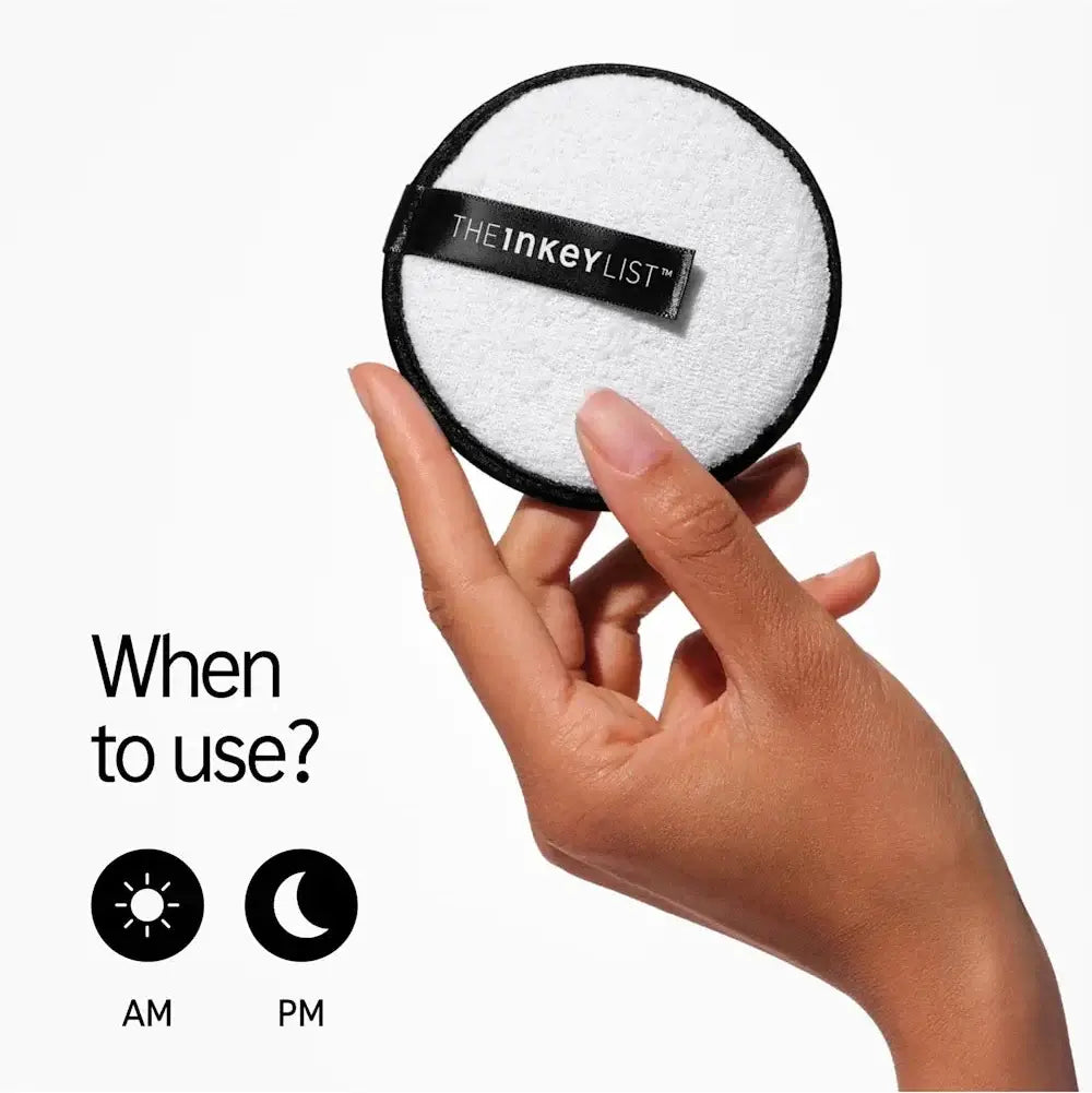 Hand holding THE INKEY LIST reusable cleansing pad, showcasing its dual-textured design for AM and PM use.
