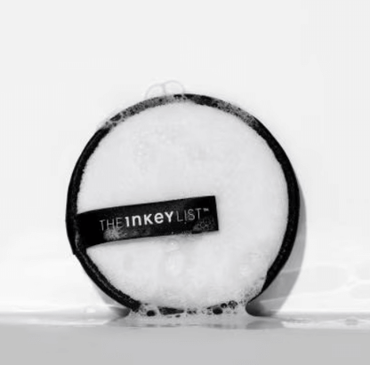 THE INKEY LIST Reusable Cleansing Pad with bubbles on a surface, showcasing its dual-textured eco-friendly design.