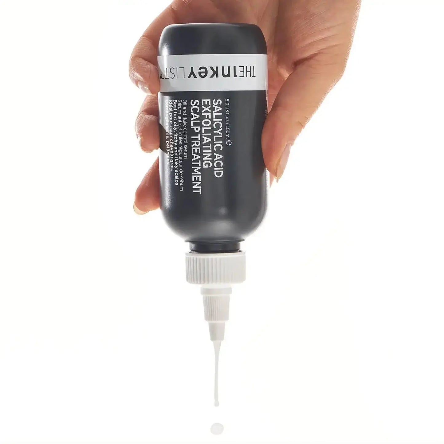 The INKEY List Salicylic Acid Exfoliating Scalp Treatment bottle in hand, ready to apply for healthy hair.