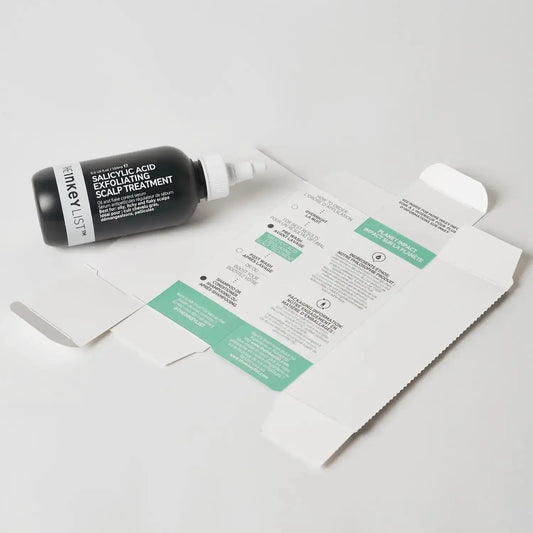 The INKEY List Salicylic Acid Exfoliating Scalp Treatment bottle beside its packaging on a white background.