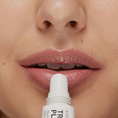 Close-up of lips applying The INKEY List Tripeptide Plumping Lip Balm 10ml for hydration and volume.