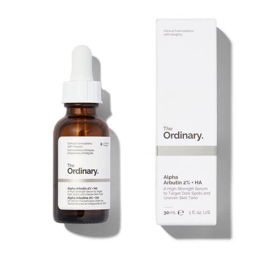 The Ordinary Alpha Arbutin 2% + HA serum in a glass bottle next to its box for brightening skin and reducing dark spots.