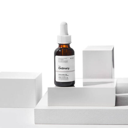 Skincare serum bottle with dropper labeled 'The Ordinary' on a white background