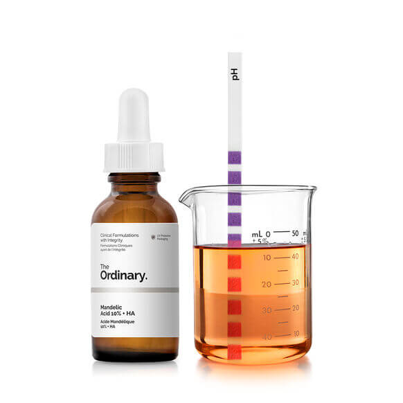 The Ordinary Mandelic Acid 10% + HA 30ml serum with beaker for pH testing, promoting radiant skin.