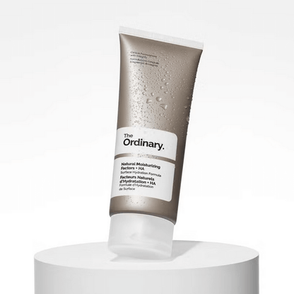The Ordinary Natural Moisturising Factors + HA tube on a pedestal, showcasing deep hydration for healthy skin.