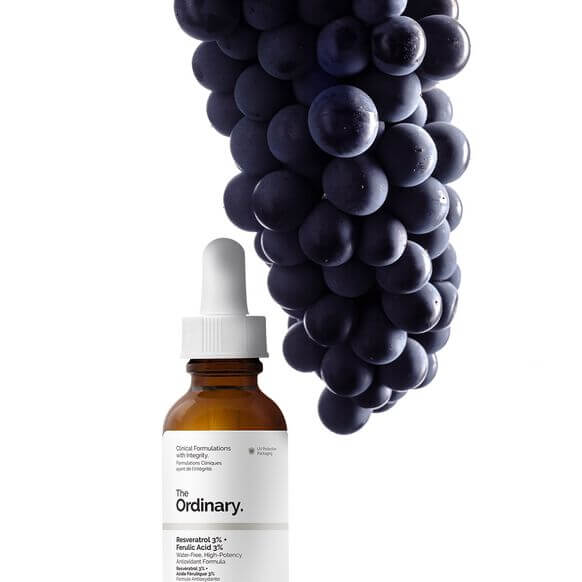 The Ordinary Resveratrol 3% + Ferulic Acid 30ml with grapes background showcasing antioxidants for radiant skin.