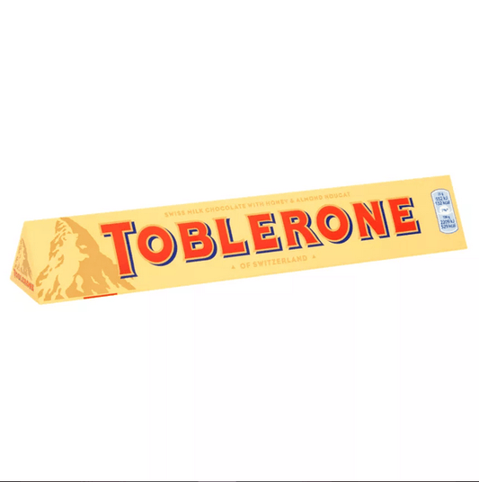 Toblerone Milk Chocolate Bar 100g packed in a yellow triangular box, showcasing Swiss milk chocolate and almond nougat.