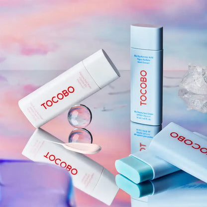 TOCOBO skincare products on a reflective surface with pastel background, featuring sun cream and hydrating lotions.