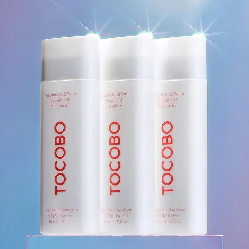 TOCOBO Vita Tone Up Sun Cream SPF50+ PA++++ bottles with Vitamin Fruit Water and B vitamins, showcasing sun protection.