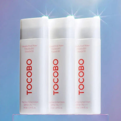 TOCOBO Vita Tone Up Sun Cream SPF50+ PA++++ bottles with Vitamin Fruit Water and B vitamins, showcasing sun protection.