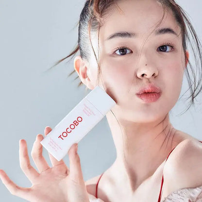 Model showcasing TOCOBO Vita Tone Up Sun Cream SPF50+ PA++++ in a bright, fresh setting