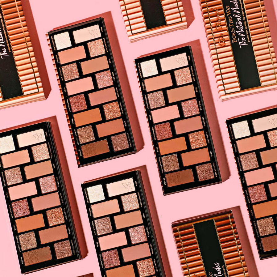 Too Faced Makeup palettes with a variety of colors on a pink background