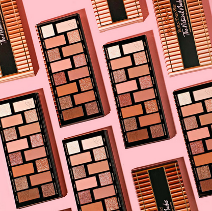 Too Faced Makeup palettes with a variety of colors on a pink background