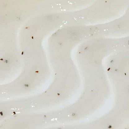 Close-up of Tree Hut Sugar Scrub Coco Colada, showcasing its creamy texture and exfoliating particles for smooth skin.