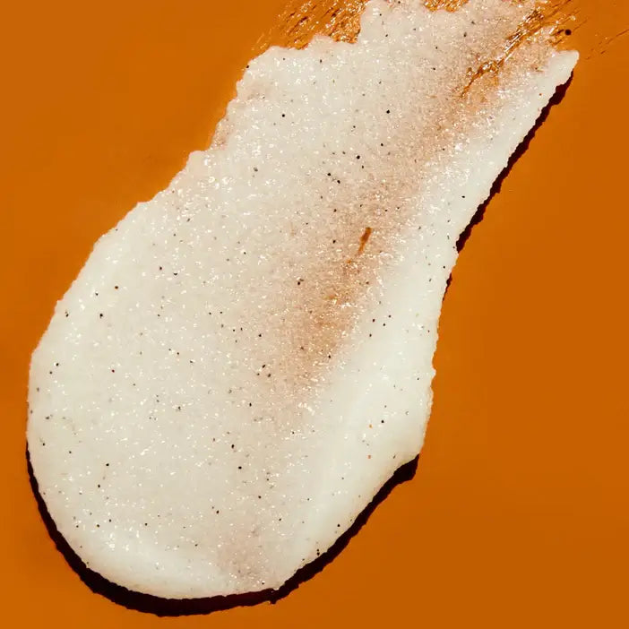 Close-up of TREE HUT Coco Colada Sugar Scrub on an orange background