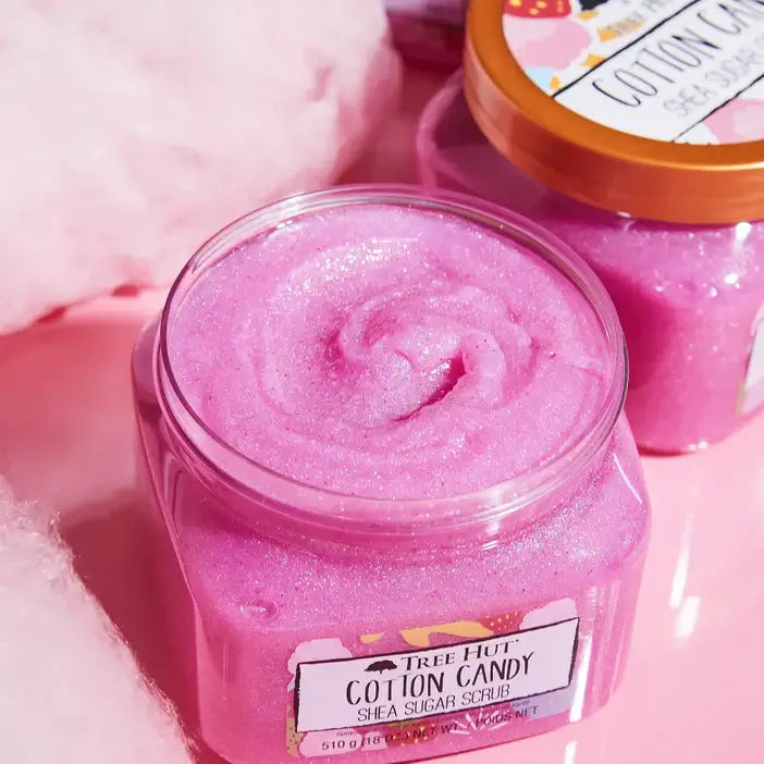 Jar of Tree Hut Cotton Candy Shea Sugar Scrub with a pink swirl texture, surrounded by cotton candy-themed elements.