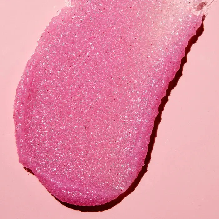 Close-up of pink glittery substance showingTREE HUT Cotton Candy Shea Sugar Scrub on a pink background