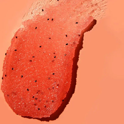 Close-up of TREE HUT Watermelon Sugar Scrub texture on a peach background
