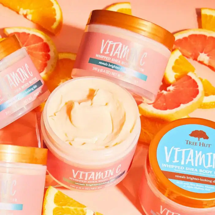TREE HUT Whipped Body Butter Vitamin C jars surrounded by grapefruit slices for radiant skin.